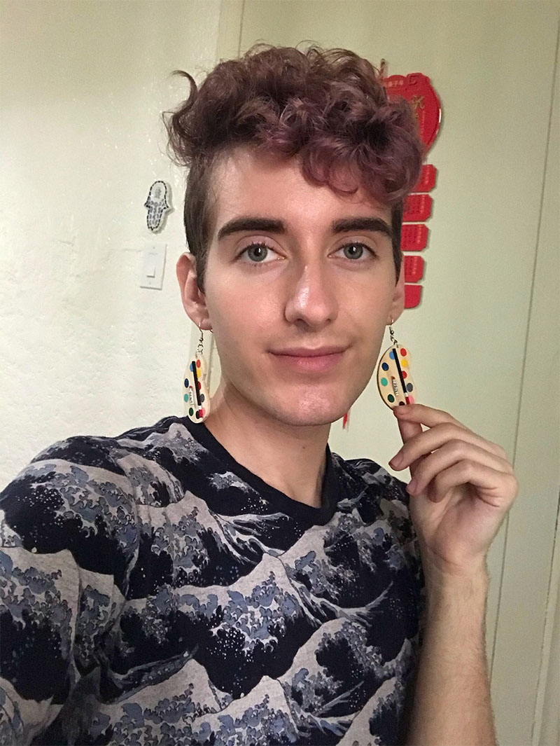 A photo of Skylar showing off his earrings.