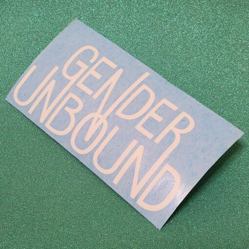 A decal of a white Gender Unbound logo on a blue temporary backing.