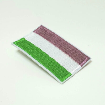 A fabric patch of a green, white, and purple genderqueer flag.