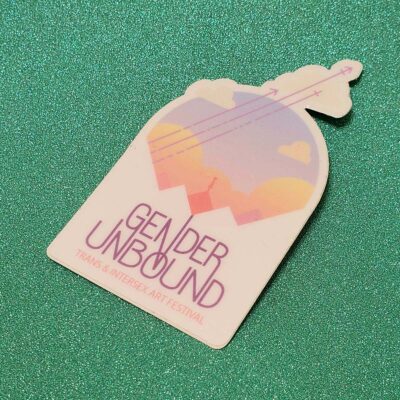 A white sticker with a color gender unbound art festival logo.